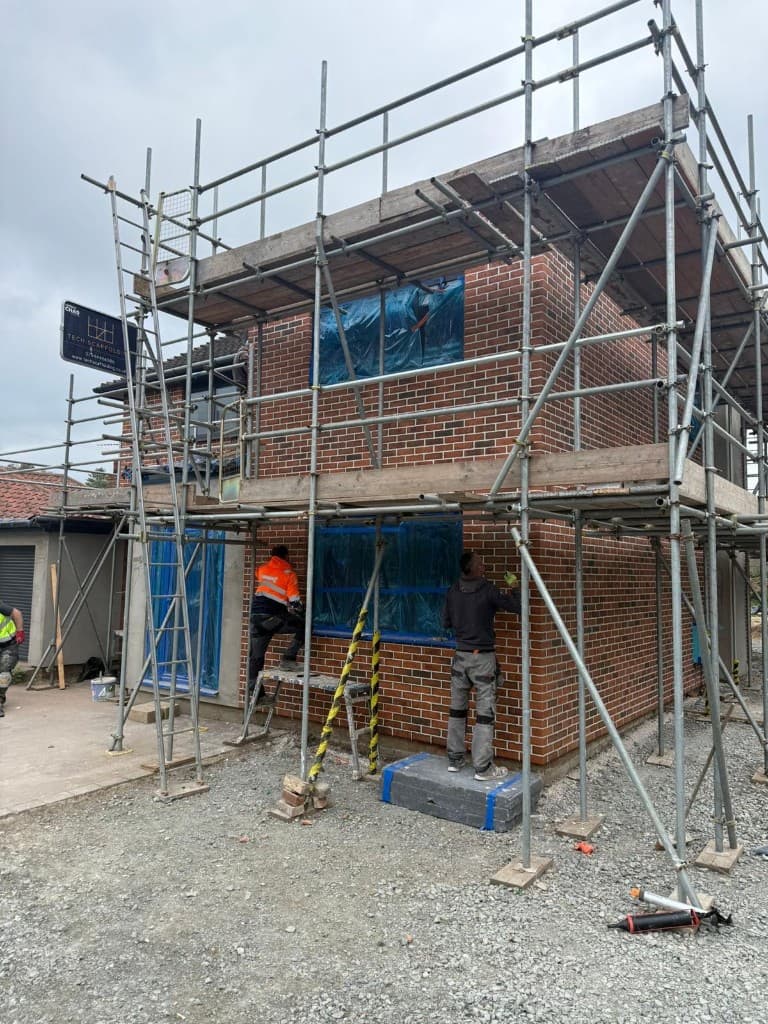 Wide view of steel frame extension structure on site